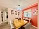 Cozy dining area with wooden table, decorative floral art, and natural lighting at 2055 S Floral Ave # 11, Bartow, FL 33830