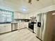 Well-lit kitchen features stainless steel appliances, ample cabinet space, and tiled backsplash at 2055 S Floral Ave # 11, Bartow, FL 33830