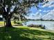 Scenic lake view with private dock, grassy shoreline and mature trees at 2055 S Floral Ave # 11, Bartow, FL 33830
