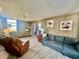 Comfortable seating area in a bright sunroom with wood-look floors and neutral decor at 2055 S Floral Ave # 11, Bartow, FL 33830