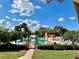 Sparkling community pool surrounded by tropical trees, lush landscaping and sunny skies at 2055 S Floral Ave # 11, Bartow, FL 33830