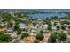High-angle view of a peaceful neighborhood near a scenic lake, surrounded by mature trees and well-maintained homes at 210 Citrus Dr, Winter Haven, FL 33884