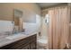 Bathroom with a vanity, toilet, and shower/bathtub combo with a shower curtain at 210 Citrus Dr, Winter Haven, FL 33884