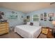 Bright bedroom with two beds, dresser and a center desk with artwork on the walls at 210 Citrus Dr, Winter Haven, FL 33884