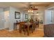 Elegant dining area with a wooden table set, mirror accents, and a stylish ceiling fan with lighting at 210 Citrus Dr, Winter Haven, FL 33884