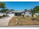 Attractive single-story home with a well-manicured lawn, a two-car garage, and a quaint front porch at 210 Citrus Dr, Winter Haven, FL 33884