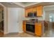 Updated kitchen featuring a stainless steel oven, a microwave, stone countertops, and wood cabinets at 210 Citrus Dr, Winter Haven, FL 33884