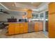 Spacious kitchen boasting wooden cabinets, stainless steel appliances, and views into the cozy Gathering room at 210 Citrus Dr, Winter Haven, FL 33884