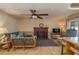 Cozy living room with a brick fireplace, ceiling fan, and comfortable seating area at 210 Citrus Dr, Winter Haven, FL 33884
