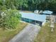 Aerial view of home featuring mature trees, long driveway and metal roof at 219 Willow St, Lake Wales, FL 33859