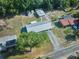 Wide aerial view showcasing the home, surrounding greenery, sheds, and neighborhood at 219 Willow St, Lake Wales, FL 33859