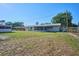 Large backyard featuring green grass and mature trees provides ample space for outdoor enjoyment and activities at 219 Willow St, Lake Wales, FL 33859