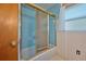 The bathroom has a glass enclosed shower and a window at 219 Willow St, Lake Wales, FL 33859