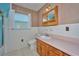 Bathroom features a vanity, toilet, and a shower with blue tiles at 219 Willow St, Lake Wales, FL 33859