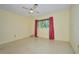 Bedroom with a ceiling fan, yellow walls, and a view to the exterior at 219 Willow St, Lake Wales, FL 33859