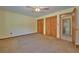 Spacious bedroom with neutral carpet, ceiling fan, and closet space at 219 Willow St, Lake Wales, FL 33859