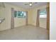 Bedroom with two windows with curtains and neutral walls at 219 Willow St, Lake Wales, FL 33859