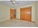 This bedroom has a view to the hallway and a closet with wooden doors at 219 Willow St, Lake Wales, FL 33859