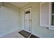 Cozy home entrance featuring a screen door and adjacent window with white shutters at 219 Willow St, Lake Wales, FL 33859
