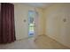 Bright entryway with a patterned floor and a view of the front yard through an open door at 219 Willow St, Lake Wales, FL 33859