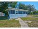Exterior view of a screened porch with plenty of windows and a separate entrance providing additional living space at 219 Willow St, Lake Wales, FL 33859