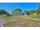 Charming home with a spacious front yard, mature trees, well-maintained lawn, and inviting curb appeal at 219 Willow St, Lake Wales, FL 33859