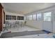 Enclosed sunroom with tile flooring, several windows and a table with chairs at 219 Willow St, Lake Wales, FL 33859