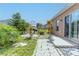 Landscaped backyard featuring a stone-tile pathway, garden, and outdoor grilling area, perfect for entertaining at 249 Haines Blvd, Winter Haven, FL 33881
