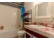 Bathroom features a white tub and shower with ocean-themed curtain, white sink with red marble-style countertops, and a dark gray wall at 249 Haines Blvd, Winter Haven, FL 33881