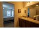 Bathroom with a vanity featuring counter space and a sink, adjacent to the entrance of the bedroom at 249 Haines Blvd, Winter Haven, FL 33881