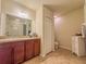 Bathroom featuring a dark brown cabinet with a spacious countertop, and a shower and toilet next to a large mirror at 249 Haines Blvd, Winter Haven, FL 33881