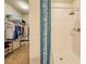 Bathroom featuring a walk-in shower, a blue patterned shower curtain, and an adjacent walk-in closet with ample storage space at 249 Haines Blvd, Winter Haven, FL 33881