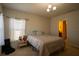 Bedroom with neutral walls, carpet, natural light, and an adjacent bathroom at 249 Haines Blvd, Winter Haven, FL 33881