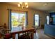 Bright dining area with natural light, an overhead chandelier, and views to the backyard at 249 Haines Blvd, Winter Haven, FL 33881