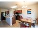 Bright dining area adjacent to a kitchen with wood cabinets and stainless steel appliances at 249 Haines Blvd, Winter Haven, FL 33881