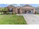Charming single-Gathering home featuring a manicured lawn, brown exterior paint, and well-maintained landscaping at 249 Haines Blvd, Winter Haven, FL 33881