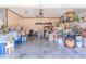 Garage with gray floor, stacked boxes, tools, and various household items at 249 Haines Blvd, Winter Haven, FL 33881