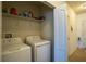 A laundry room with a washer and dryer and storage at 249 Haines Blvd, Winter Haven, FL 33881