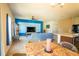 Open living space with dining area, blue accent wall, and modern ceiling fan at 249 Haines Blvd, Winter Haven, FL 33881
