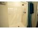 Shower area featuring white tiling, a modern shower head, and a blue shower curtain at 249 Haines Blvd, Winter Haven, FL 33881