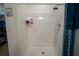 Shower area featuring white tiling, a modern shower head, and a blue shower curtain at 249 Haines Blvd, Winter Haven, FL 33881