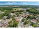 Aerial shot of a residential area showcasing a mix of homes, green spaces, and a clear blue sky at 259 Mariposa, Winter Haven, FL 33884