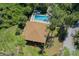 Aerial view of home featuring pool and wooded grounds at 259 Mariposa, Winter Haven, FL 33884