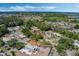 An aerial shot captures a well-planned community featuring landscaped yards and a nearby lake, highlighting a desirable location at 259 Mariposa, Winter Haven, FL 33884