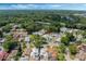 A high-angle shot showcases a suburban neighborhood nestled among mature trees and greenery at 259 Mariposa, Winter Haven, FL 33884