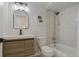 Well-lit bathroom featuring modern fixtures, neutral tiles, a shower-tub combo, and a stylish vanity at 259 Mariposa, Winter Haven, FL 33884