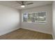 This spacious bedroom boasts hardwood floors, a ceiling fan, and a large window offering ample natural light at 259 Mariposa, Winter Haven, FL 33884