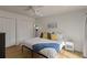 Cozy bedroom features a comfortable bed with decorative pillows, wood floors, and large closets for ample storage at 259 Mariposa, Winter Haven, FL 33884