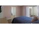 Cozy pink bedroom with private patio and easy access to the ensuite bathroom at 259 Mariposa, Winter Haven, FL 33884