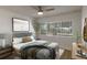 Bright bedroom with large window, ceiling fan, hardwood floors, and stylish furniture creates a cozy atmosphere at 259 Mariposa, Winter Haven, FL 33884